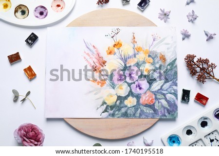 Flat lay composition with floral picture and watercolor paints on white background