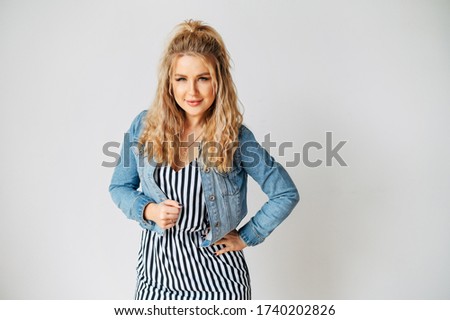 Fashion posing. Studio shot of young beauty woman in casual wear. Horizontal photo isolated on white background