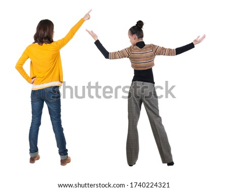 Back view of two young woman photographed on a mobile phone in sweater. Rear view people collection. backside view of person. Rear view. Isolated over white background.