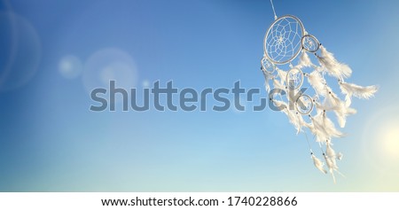 Dream catcher on blue sky sunset background with copy space Royalty-Free Stock Photo #1740228866