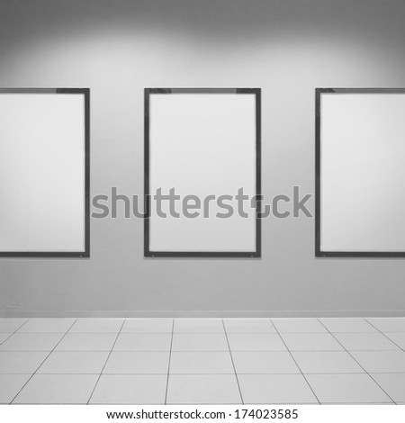 Three vertical poster on textured wall. Blank template