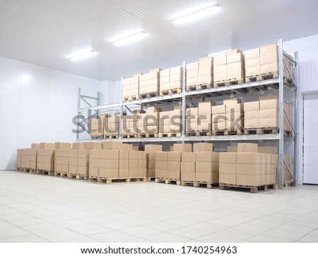 Modern warehouse refrigerator finished goods in cardboard boxes, background. Pharmaceutical Storage Concept, copy space