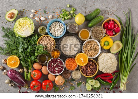 concept balanced diet of fruits, vegetables, seeds, legumes, grains, cereals, herbs and spices. Products containing vitamins, mineral salts, antioxidants, fiber, concrete background. Royalty-Free Stock Photo #1740256931