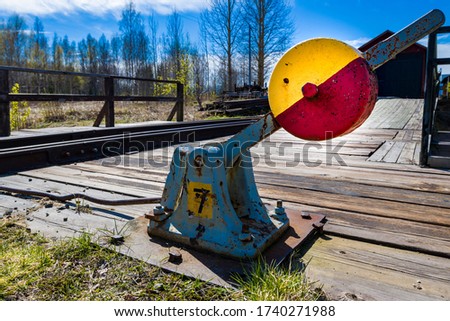 Manual railway gear, old narrow gauge. Small locomotive sheds in the background.
