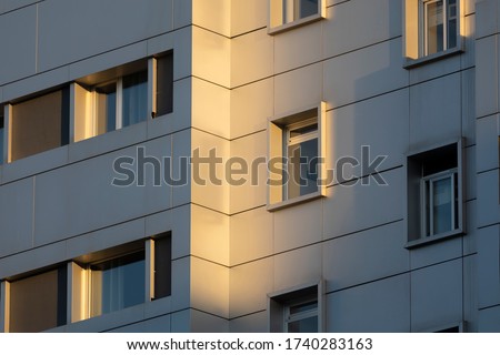Facades of anonymous buildings, illuminated by the afternoon light, in the Retiro district of Madrid, Spain.