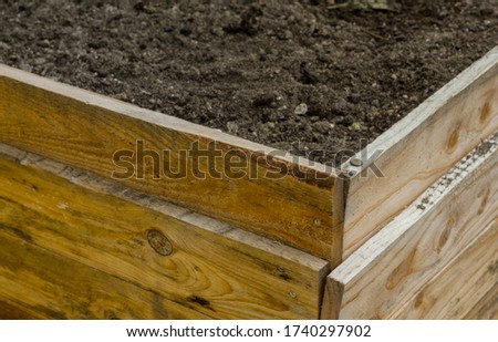 Home-made raised bed plant bed made of old wood ready for planting environmental recycling do it yourself home nails improvement hobby