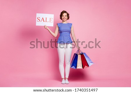 Full length body size view of her she nice-looking attractive lovely pretty fashionable cheerful cheery wavy-haired girl carrying new things board word sale isolated on pink pastel color background