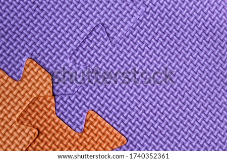 background puzzles of lilac and orange colors bonded together