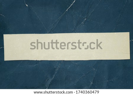 White paper on old blaue background. Grunge texture. Vintage page