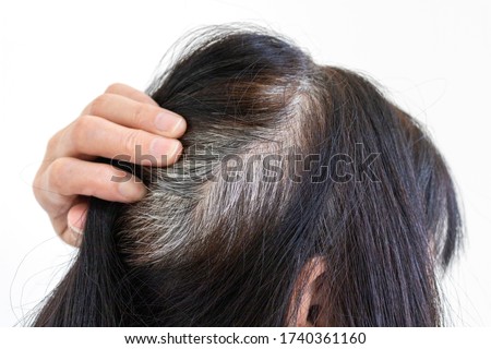 Head of an elderly woman with gray hair that grew after dyeing Royalty-Free Stock Photo #1740361160
