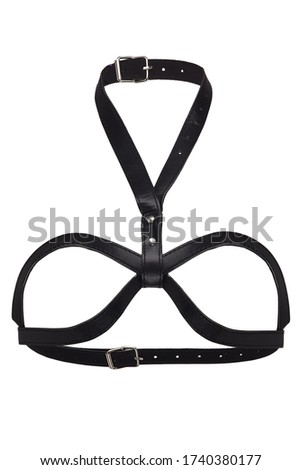 Detailed shot of a black leather open cup bra with a neck strap, rivets and steel buckles. The stylish garment is isolated on the white background.