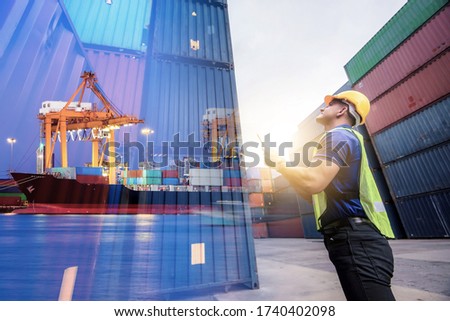 Double exposure, Caucasian man engineer using digital tablet and wearing yellow safety helmet and check for control loading containers box from Cargo freight ship for import and export, transport.
