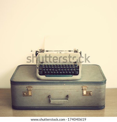 Typewriter and vintage suitcase 