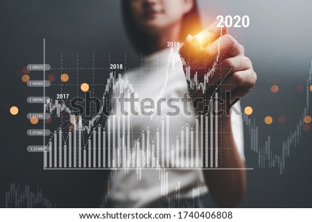 Businesswoman draw growth graph and progress of business and analyzing financial and investment data ,business planning and strategy on grey background.