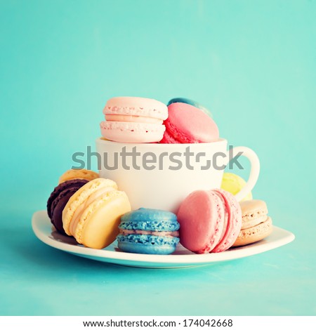 Sweet and colourful french macaroons on retro-vintage background 