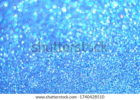 Blue bokeh lights abstract background. Dark blurred blue backdrop. Defocused, copy space.
