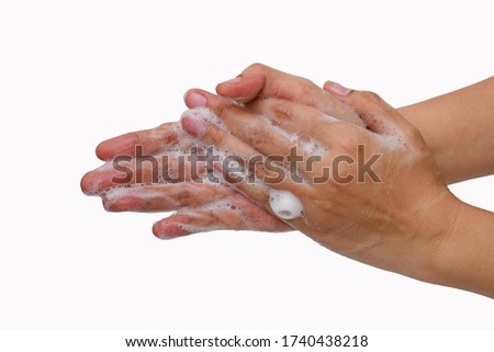 The photo picture of woman's hands taken when she washes her hands with soap isolated on the white background.