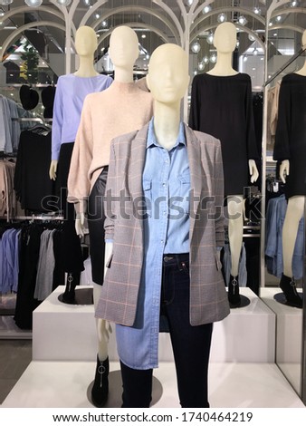 Mannequin in a shop window. Sale of clothes for men and woman 

