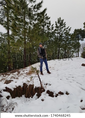 This is a Beautiful Snowfall Ice Area Seen with Cute Boy Wearing Jacket, Ice on Clothes look good, Seen of Japan, Canada, Murree Snowfall Winter Cold outdoor seen