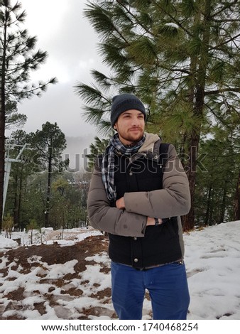 This is a Beautiful Snowfall Ice Area Seen with Cute Boy Wearing Jacket, Ice on Clothes look good, Seen of Japan, Canada, Murree Snowfall Winter Cold outdoor seen