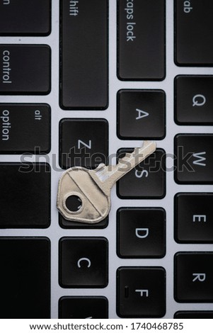 Key at keyboard. Security concept image