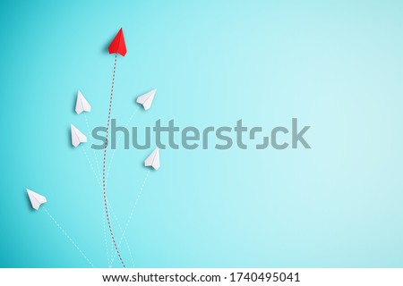 Red paper plane out of line with white paper to change disrupt and finding new normal way on blue background. Lift and business creativity new idea to discovery innovation technology.