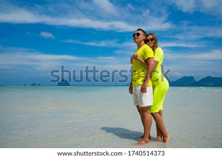 Young happy couple on tropical beach at summer vacation. Thailand