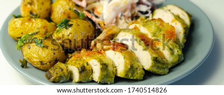 Pesto and mozzarella chicken breast fillet with herby baby potatoes and creamy coleslaw salad, delicious dish Royalty-Free Stock Photo #1740514826