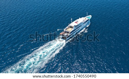 Aerial drone photo of luxury yacht cruising in high speed in open ocean deep blue sea
