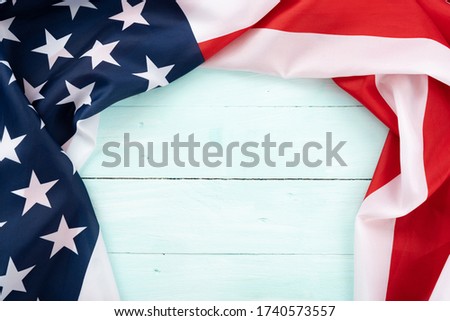 US American flag on blue wooden background. For USA Memorial day, Presidents day, Veterans day, Labor day, Independence or 4th of July celebration. Top view, copy space for text.