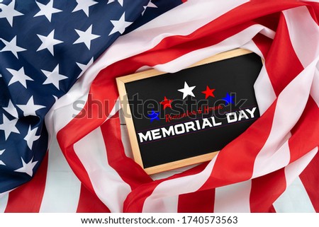 US American flag with blackboard on blue wooden background. For USA Memorial day. Top view with memorial day text.