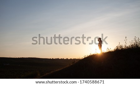 Senior man looking at the horizon in the field on top of a hill in backlight. Royalty-Free Stock Photo #1740588671
