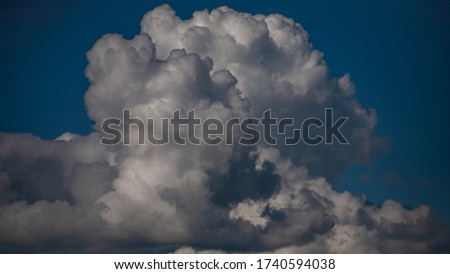 Thundercloud close-up on a background of blue sky