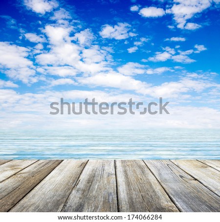 wooden pier sea and sky with clouds
