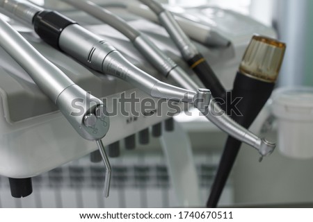 Dental handpiece. Equipment and dental instruments in dentist's office. Tools close-up. Dentistry. Stomatological tools. Shallow depth of field. Royalty-Free Stock Photo #1740670511