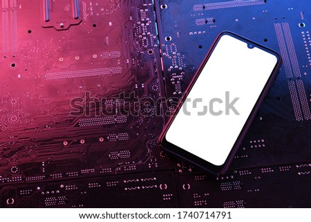 Smartphone frame less blank screen on computer motherboard tecnologic background. Mockup generic device.Template for infographics or presentation.Top view.