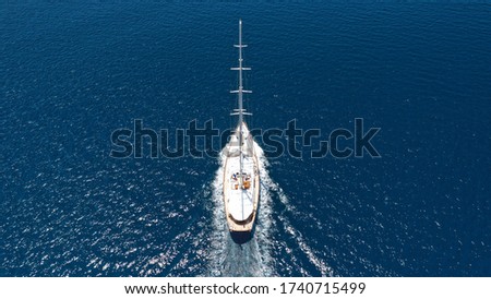 Aerial drone photo of luxury sail boat cruising in the deep blue Aegean sea, Greece