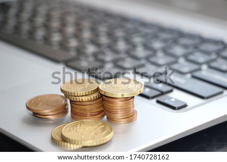 Bronze color euro cents coins on computer keyboard. Online trading concept. Internet business virtualproducts and servises concept.