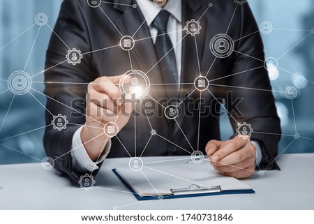A business man works in a network of connections with his staff.