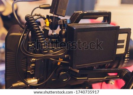 Video operator shoots on camera. Video camera with a transmitting device over Wi-Fi. Video production. Videographer in headphones. Video stream.