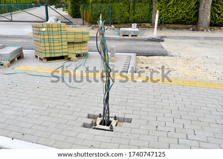Place for mounting a road lighting pole.Two cables are prepared for connecting the lighting pole.
Replacing the road surface.