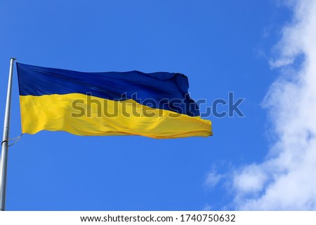 Large national flag of Ukraine flies in the  sky. Big yellow blue Ukrainian state flag in the Dnepr city, Independence, Constitution, Defender s Day, National Holiday, space for text