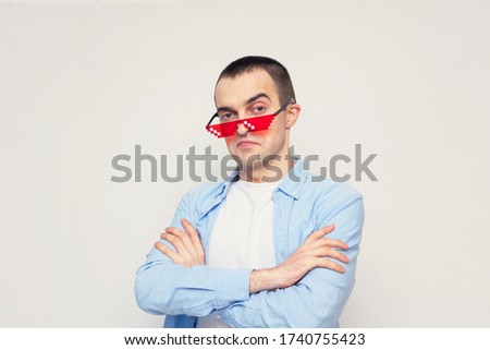 Haughty man film fan with pixel glasses, person with cross his arms, portrait, white background