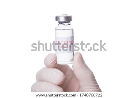 Immunization and treatment concept. Close-up macro cropped photo of professional practitioner therapist doctor holding a vial of COVID-19 vaccine isolated on white background