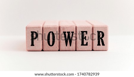 Concept word forming on wooden cube on white background - power