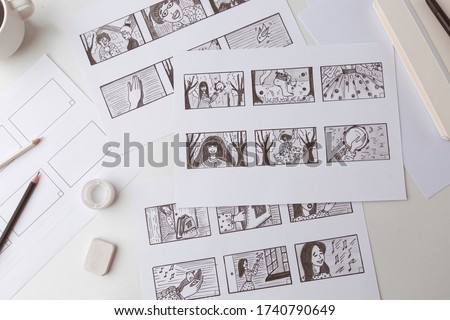 Workplace artist animator drawing a storyboard for a cartoon. Pre-production for the film. The designer creates sketches for the comics. Royalty-Free Stock Photo #1740790649