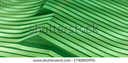 a green abstract linear composition of a wave shaped glass panes