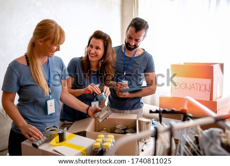 Volunteers working in charitable foundation Warehouse on helping homeless people.Social workers who provide humanitarian assistance to a disadvantaged person Royalty-Free Stock Photo #1740811025