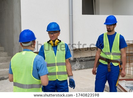 The foreman on the construction site gives instructions to the workers