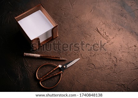Office utensils in vintage style on a rustic background. Scissors, pen, pencil and notes.